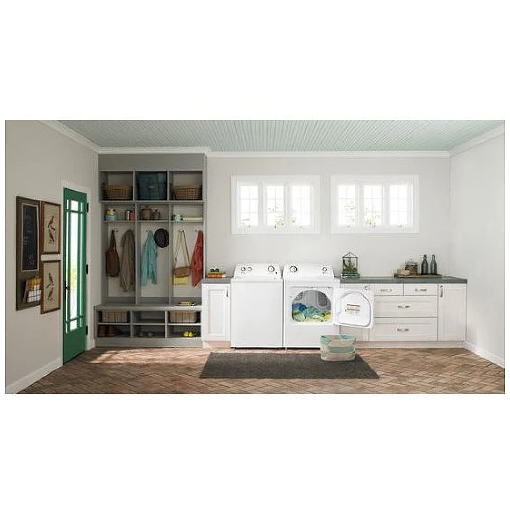 Used Amana YNED4655EW electric dryer in a clean laundry nook beside kitchen cabinetry