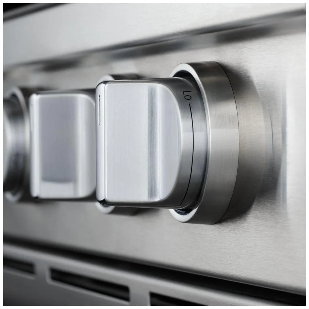 Close-up of the sleek, stainless steel knob on the gas range, emphasizing its durable, weighted design for easy control of cooking settings.